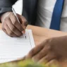 Someone signing a document | FREEPIK