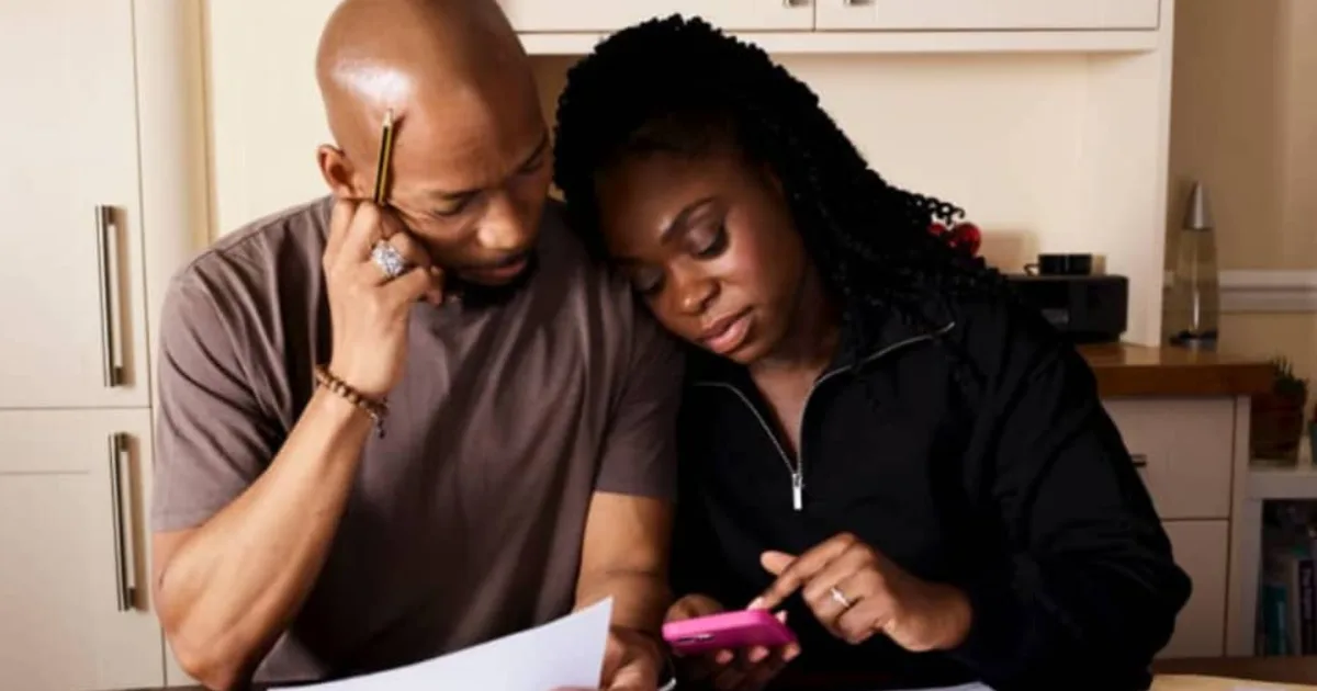 Couple reviewing documents as a first-time home buyer